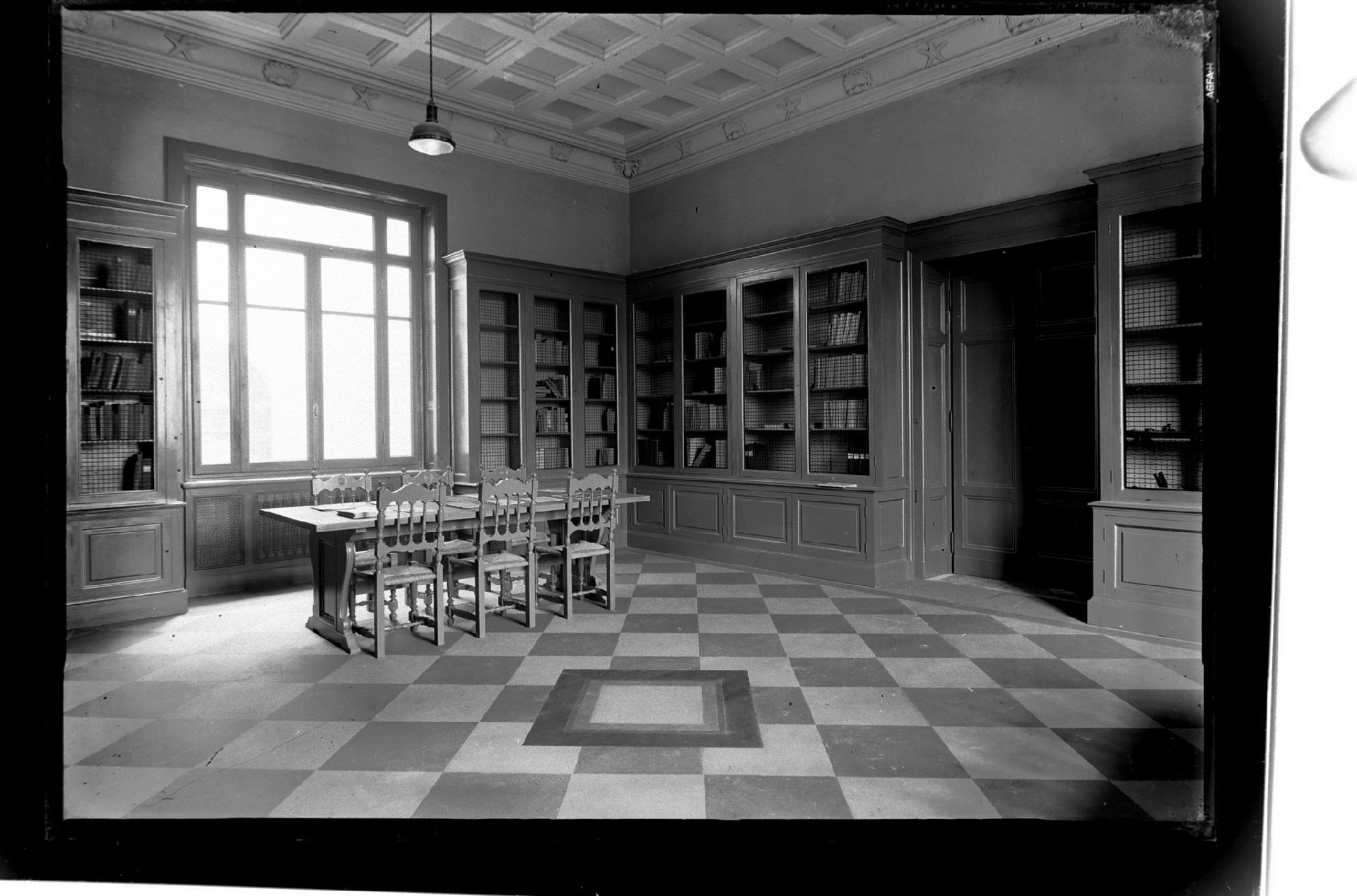 The wooden library of the Istituto Talassografico. Worthy of note are the coffered ceiling and plaster cornice with decorations depicting marine subjects - Attilio Cerruti